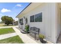Charming white home with a neatly landscaped front yard, wrought iron bench, and a welcoming entrance at 5808 W Myrtle Ave, Glendale, AZ 85301
