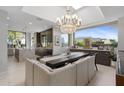 Open concept dining area with a large chandelier, adjacent to the kitchen with an eat-in breakfast bar at 5905 N Echo Canyon Ln, Phoenix, AZ 85018