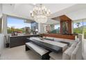 Bright dining room with chandelier, built in seating, and gorgeous backyard views through a large window at 5905 N Echo Canyon Ln, Phoenix, AZ 85018