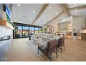 Open-concept living room features wood beams, large windows, and comfortable seating area at 6126 E Charter Oak Rd, Scottsdale, AZ 85254