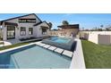 Inviting pool and spa area with guest house, bar, and beautifully landscaped yard at 6126 E Charter Oak Rd, Scottsdale, AZ 85254