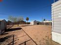 Large backyard with a storage shed and mature trees, offering plenty of space for outdoor activities at 614 W 12Th St, Casa Grande, AZ 85122