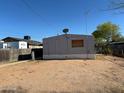View of a single-story home in need of repairs with desert landscaping at 614 W 12Th St, Casa Grande, AZ 85122