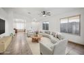 Inviting living room showcasing neutral tones, tile floors, large windows, and comfortable seating at 6309 W Hughes Dr, Phoenix, AZ 85043