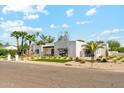 Lovely single story home featuring a manicured lawn and minimalist desert landscaping at 7001 E Joan De Arc Ave, Scottsdale, AZ 85254