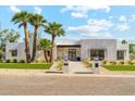 Beautiful modern home with white brick, manicured lawn, and desert landscaping at 7001 E Joan De Arc Ave, Scottsdale, AZ 85254