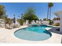 Inviting backyard pool area with lush landscaping, lounge chairs, and a privacy fence at 7020 E Friess Dr, Scottsdale, AZ 85254
