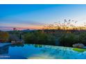 Tranquil view from the infinity pool overlooking scenic desert landscape, perfect for relaxation and sunset viewing at 9045 E Chino Dr, Scottsdale, AZ 85255