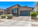 Well-maintained home featuring modern windows, desert landscaping, and a convenient two-car garage at 939 E Paseo Way, Phoenix, AZ 85042