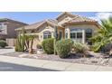 Charming single-Gathering home featuring beautiful desert landscaping, a fountain, and a two-car garage at 9722 S 45Th Ave, Laveen, AZ 85339