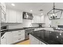 Kitchen with stainless steel Viking appliances, black granite countertops, and shaker cabinets at 1018 W State Ave, Phoenix, AZ 85012