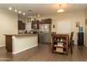 Open kitchen features stainless steel appliances, tile flooring and an eat-in dining area at 10225 W Camelback Rd # 45, Phoenix, AZ 85037