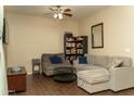 Bright living room with a ceiling fan, gray sectional sofa, and modern furnishings at 10225 W Camelback Rd # 45, Phoenix, AZ 85037