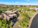 Stunning home with desert landscaping, mature trees, brick driveway, and an attached two-car garage at 10664 E Monument Dr, Scottsdale, AZ 85262