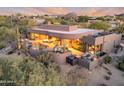 Expansive home featuring an outdoor pool, hot tub, patio with outdoor furniture and panoramic desert views at 10664 E Monument Dr, Scottsdale, AZ 85262