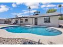 Enjoy the Arizona sunshine in this sparkling pool featuring a pebble tec surround with easy access from the home at 13215 N 30Th Pl, Phoenix, AZ 85032