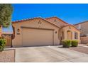 Charming single-story home with a well-maintained front yard, desert landscaping, and two-car garage at 17693 W Lincoln St, Goodyear, AZ 85338