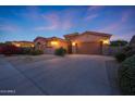 Charming single-story home featuring a well-maintained landscape, a two-car garage, and stone accents at 17975 W Willow Dr, Goodyear, AZ 85338