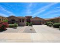 Charming single-story home boasts desert landscaping, a brick walkway, and a two-car garage at 17975 W Willow Dr, Goodyear, AZ 85338