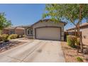 Charming single-story home featuring a two-car garage and low-maintenance desert landscaping at 20251 W Madison St, Buckeye, AZ 85326