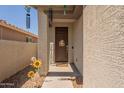 Inviting front porch featuring a dark wood door, cute decorations, and warm welcome at 20251 W Madison St, Buckeye, AZ 85326