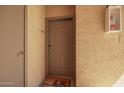 Close-up of a condo front door with a 'hello' doormat and secure entry features at 2134 E Broadway Rd # 2030, Tempe, AZ 85282
