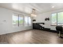 Spacious living room featuring modern lighting, black stacked stone, and luxury vinyl plank flooring at 21655 N 36Th Ave # 131, Glendale, AZ 85308
