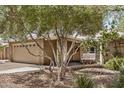 Exterior of tan brick home with covered porch and a swing at 2256 S Las Flores --, Mesa, AZ 85202