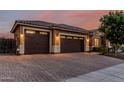 Attached three-car garage with brick paved driveway and tile roof at 2741 E Odessa St, Mesa, AZ 85213