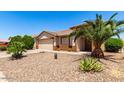 Single-story house featuring a two-car garage, desert landscaping, and a clear blue sky at 30601 N Royal Oak Way, San Tan Valley, AZ 85143
