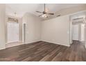 Living room with sleek wood floors, ceiling fan, and neutral wall color at 30601 N Royal Oak Way, San Tan Valley, AZ 85143