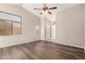 Cozy living room featuring stylish wood flooring and a ceiling fan at 30601 N Royal Oak Way, San Tan Valley, AZ 85143