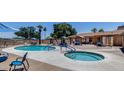 Relaxing pool and hot tub area with ample seating, shade structures, and a building in the background at 3307 E Kings Ave, Phoenix, AZ 85032