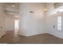 Bright foyer with high ceilings, tile floors, and a modern chandelier at 3837 E Windsong Dr, Phoenix, AZ 85048
