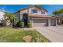 Charming two-story home with a well-manicured lawn and a spacious three-car garage at 3837 E Windsong Dr, Phoenix, AZ 85048