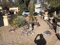 Front yard features desert landscaping, gravel, cacti, rock details, and a concrete sitting bench at 401 W Cape Royal Ln, Phoenix, AZ 85023
