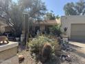 Desert landscaping and cacti in front yard with an appealing southwest house with a charming desert landscape at 401 W Cape Royal Ln, Phoenix, AZ 85023