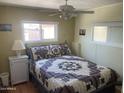 Cozy bedroom featuring a large bed with classic quilt and natural light at 4065 E University Dr # 155, Mesa, AZ 85205