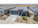 Aerial view of a single-story home boasting stone accents, low-maintenance landscaping, and a two-car garage at 40848 W Hillman Dr, Maricopa, AZ 85138
