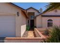 Inviting front entry showcasing beautiful desert landscaping and architectural details at 4313 E Briarwood Ter, Phoenix, AZ 85048