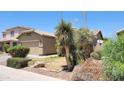 Exterior side view of a single-story home with low maintenance desert landscaping at 4432 W Pleasant Ln, Laveen, AZ 85339