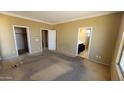 Spacious main bedroom with neutral walls, carpeting, and access to bathroom and closet at 4432 W Pleasant Ln, Laveen, AZ 85339