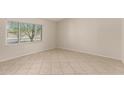 Bright, airy bedroom with tiled flooring and large windows at 4510 N 105Th Ave, Phoenix, AZ 85037