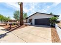 Beautiful single-story home featuring desert landscaping and a large driveway leading to the garage at 4510 N 105Th Ave, Phoenix, AZ 85037