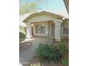 Inviting front entry with decorative columns and lush landscaping at 4513 E Grovers Ave, Phoenix, AZ 85032