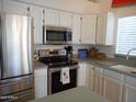 Kitchen features stainless steel appliances, including refrigerator, microwave, and range at 4513 E Grovers Ave, Phoenix, AZ 85032
