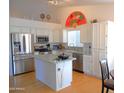 Bright kitchen with stainless steel appliances, island and ample cabinet space at 4513 E Grovers Ave, Phoenix, AZ 85032