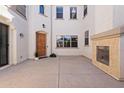 Inviting courtyard entrance with a wooden door, fireplace, and neutral color palette for an open feel at 4517 W Lodge Dr, Laveen, AZ 85339