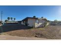 Single-story home featuring a covered parking and minimal desert landscaping at 4721 N 55Th Dr, Phoenix, AZ 85031