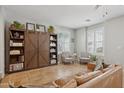 Open living room with a large shelving unit, tile floors, neutral walls, and bright windows at 4772 E Portola Valley Dr # 102, Gilbert, AZ 85297